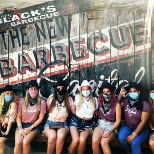 bachelorette group wearing masks posing at Terry Black's BBQ