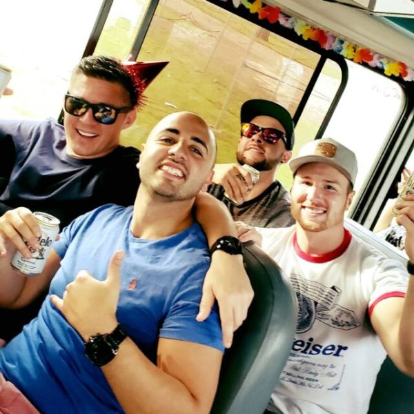 a group of people posing on a party bus