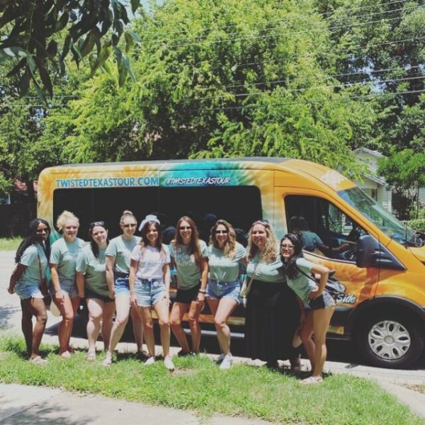 a group of bachelorettes posing for a picture by orange and teal tie dye van