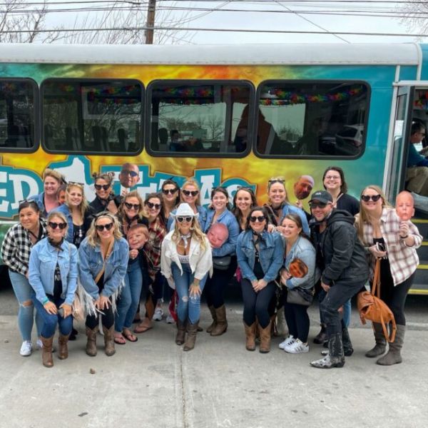 a group of people standing in front of a bus