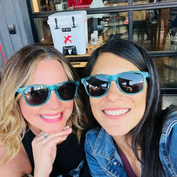 a woman wearing sunglasses posing for the camera