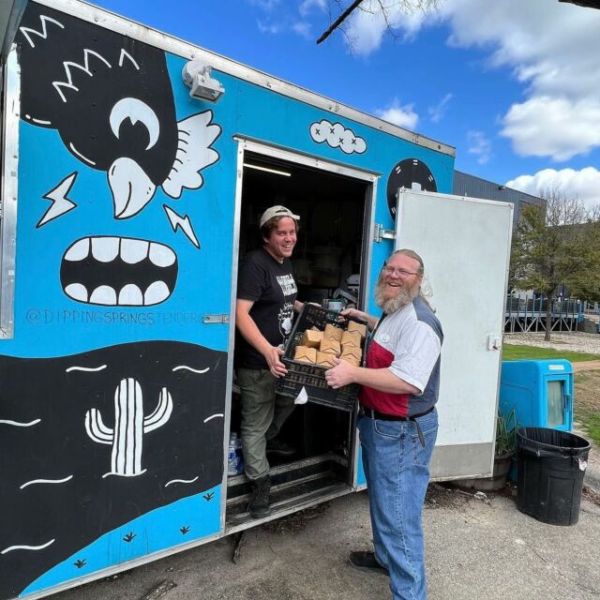a person holding a sign posing for the camera