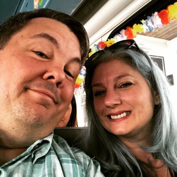 a close up of a man and a woman smiling for the camera