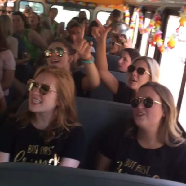group of smiling people listening to live music