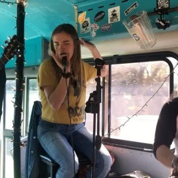 Woman singing into microphone passionately