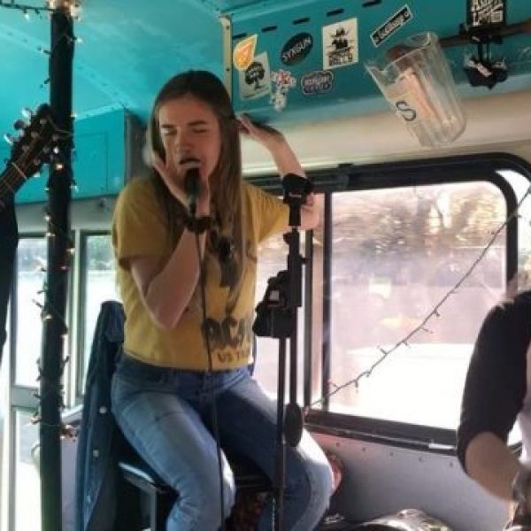 Woman singing into microphone passionately