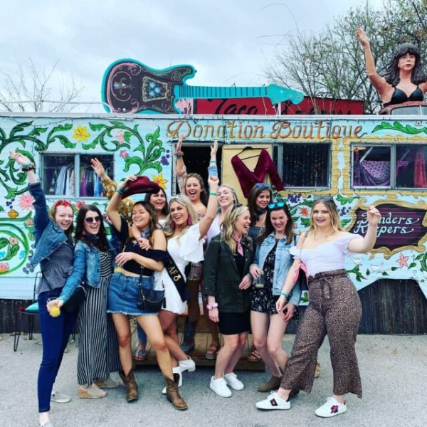 bachelorette group in fun poses in front of food truck
