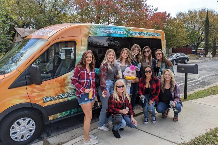 a group of people standing in front of a bus