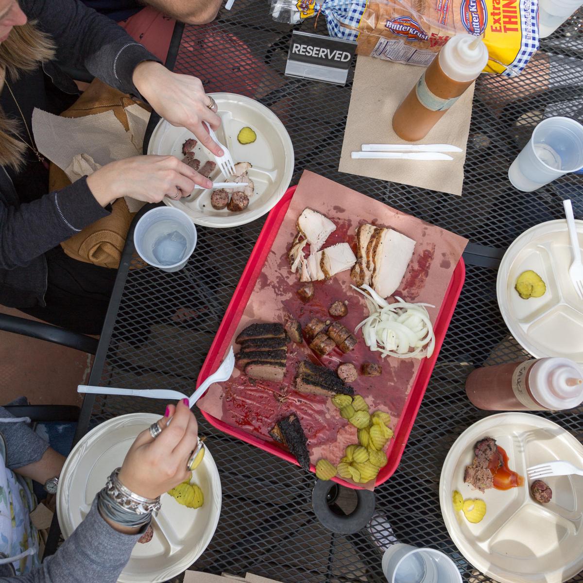 a person sitting at a table with a plate of food