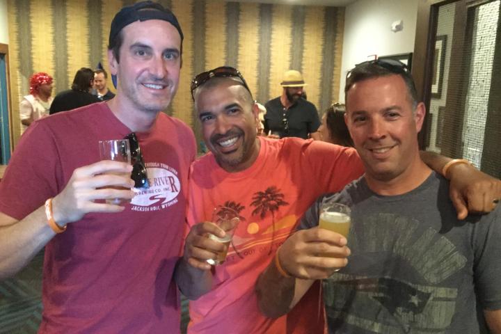 a man holding a wine glass posing for the camera