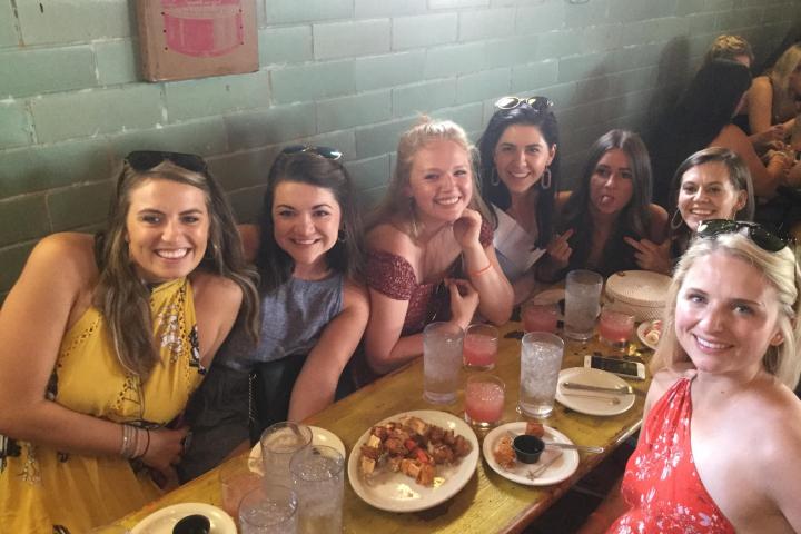 a group of people sitting at a table posing for the camera