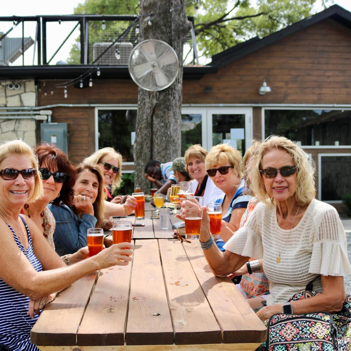 a group of people sitting at a picnic table