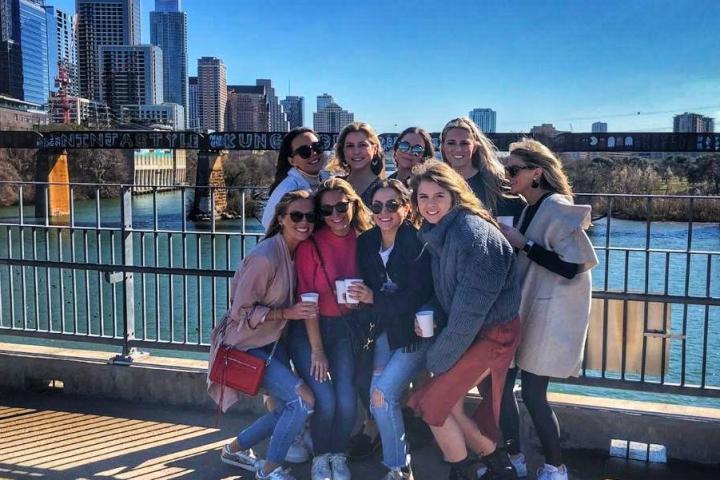 a group of people sitting on a bench in the city