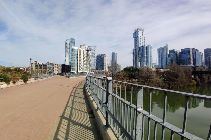 a bridge over a body of water with a city in the background