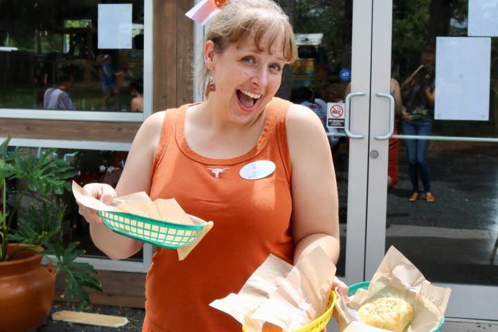 a woman holding a tray of food