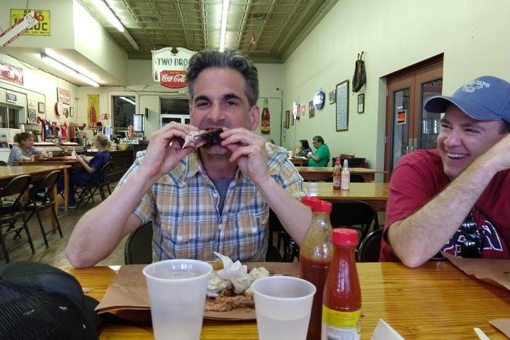a person sitting at a table eating food