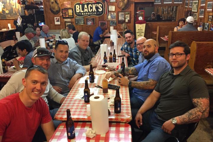 a group of people sitting at a table in a restaurant