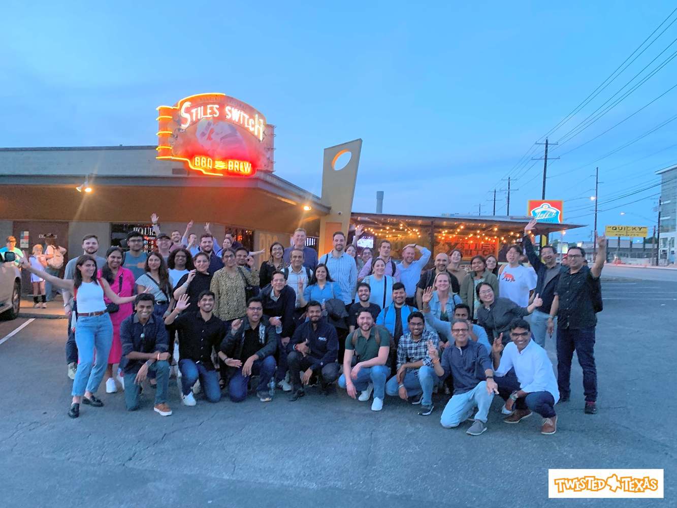 Group of people posing outside Stiles Switch restaurant in Austin
