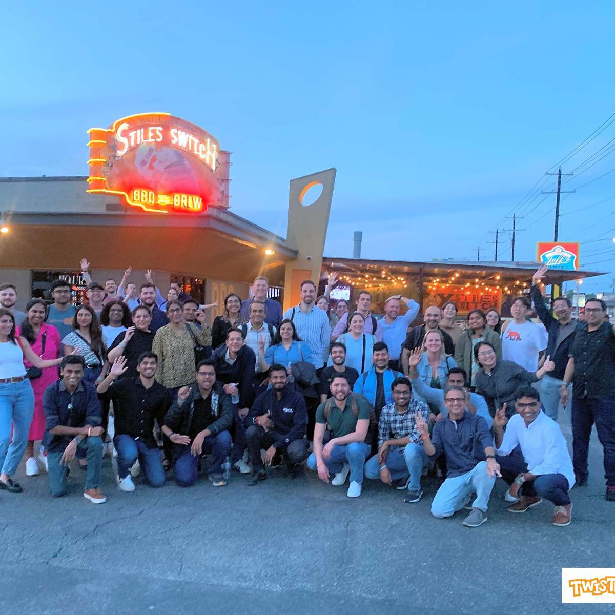 Group of people posing outside Stiles Switch restaurant in Austin